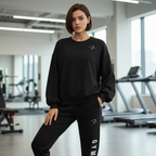 Woman wearing a black sweatshirt and black pants with 'GYM' text in a gym setting