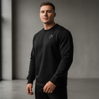 Man wearing a black sweatshirt with a logo against a gray background