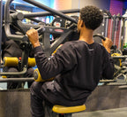 Person using a gym machine in a fitness center