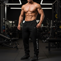 Muscular person wearing black gym wear Crest Jogger in a gym setting